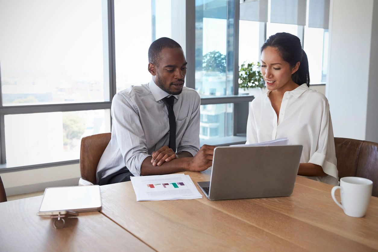 Professional woman working on laptop in modern office space for social good initiatives
